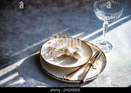 Easter place setting with eggs and dried flowers on a table Stock Photo