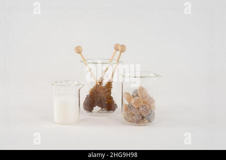 Various sugar crystals. The brown rock candy is mainly used to sweeten drinks. The white sugar is mainly used in the kitchen. Stock Photo