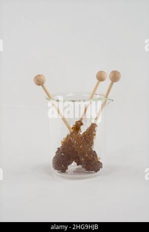 Kantis sugar crystals on a wooden stick. This is used to sweeten tea. Stock Photo