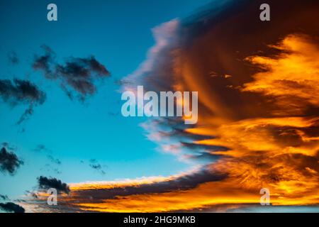 Golden orange clouds against blue skies over the Mediterranean during sunset wallpaper background Stock Photo