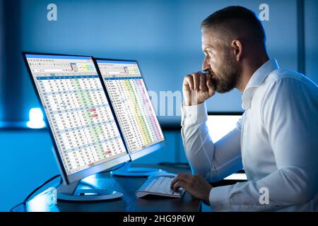 Analyst Working With Spreadsheet Business Data On Computer Stock Photo