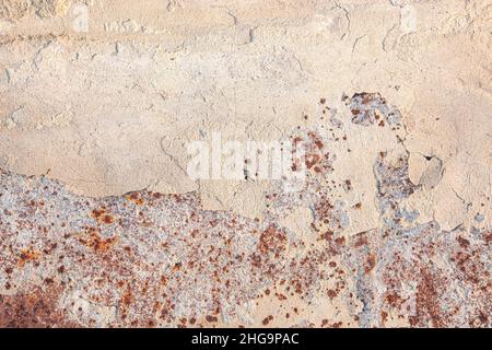 The old rusted surface is partially covered with crumbled whitewash with shadow. Natural textured background. Stock Photo