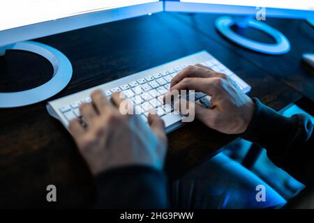 Male Hacker Stealing Data From Computer In Office Stock Photo