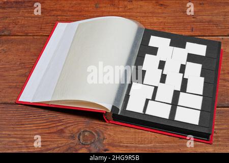 Postage stamps frames set in vintage album on wooden table Stock Photo