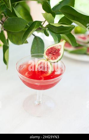 Red drink with ice. Alcoholic beverages decorated with fresh fig fruits on white background. Campari aperol drink Stock Photo