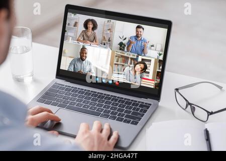 Video Conference. Businessman Using Laptop For Online Corporate Meeting With Diverse Colleagues Stock Photo