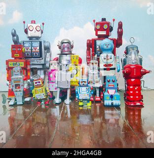 a large group of retro tin robot toys on a old wooden floor  with reflection Stock Photo