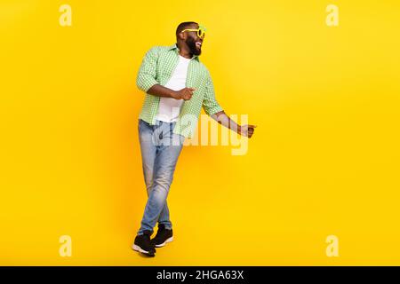 Full body portrait of satisfied overjoyed person enjoy partying dancing isolated on bright yellow color background Stock Photo