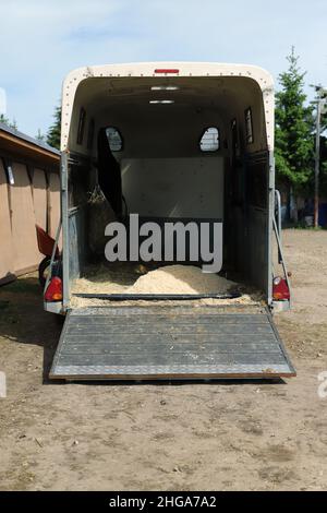 An empty horse trailer with open back door, rear view Stock Photo