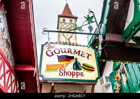 Helen, USA - October 5, 2021: Bavarian village of Helen, Georgia with traditional architecture tower roof and colorful building sign for the Gourmet S Stock Photo