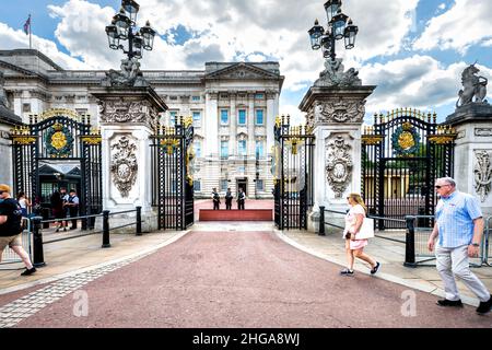 London, UK - June 21, 2018: English Royal security guards police officers with automatic weapons guns standing in front of Buckingham Palace in center