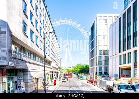 London, UK - June 22, 2018: Road alley street with London Eye Millennium ferris wheel by buildings near City Hall headquarters in South Bank on summer