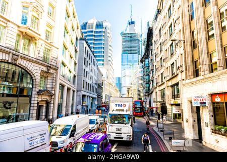 London, UK - June 22, 2018: Red double-decker bus on street alley wide angle view with business city of London district with construction skyscraper m Stock Photo