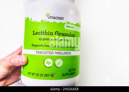 Naples, USA - October 21, 2021: Closeup macro hand holding supplement product by Vitacost Kroger brand for Soy lecithin granules label sign text for h Stock Photo