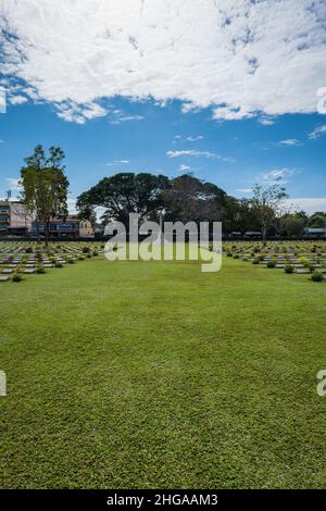 Kanchanaburi, Thailand - December 2021: The Kanchanaburi War Cemetery (known locally as the Don-Rak War Cemetery), the main prisoner of war (POW) Stock Photo