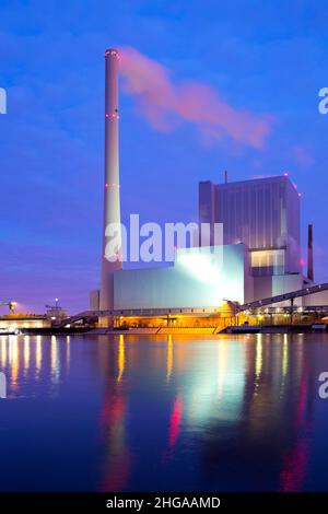 Large illuminated coal power plant causing global warming and climate change Stock Photo