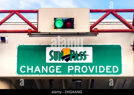 Miami, USA - August 5, 2021: Sign for SunPass toll Sun Pass change provided text with green light on i-75 road street highway from Miami Ft Lauderdale Stock Photo