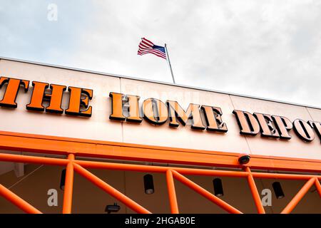Naples, USA - August 14, 2021: The Home Depot store sign on building in Naples, Florida strip mall plaza with orange color and American Flag Stock Photo