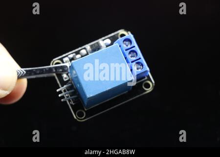 Single channel relay module isolated on black background, Electronic relay to control high voltage into low voltage Stock Photo