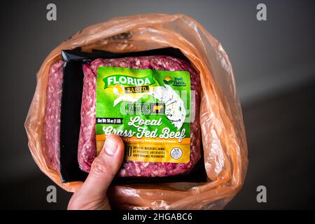 Naples, USA - September 1, 2021: Fresh from Florida brand sign closeup of packaged free range local grass-fed raised red raw beef ground meat bought a Stock Photo
