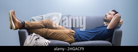 Photo Of Man Relaxing On Sofa At Home Stock Photo