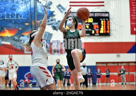 USA. Player finishing off a drive on the basket while attempted to score over an opponent. Stock Photo