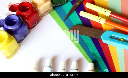 Art work,Colour paper,colour tube, pen and knife on a white background Stock Photo