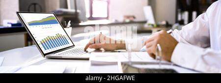Business Advisor Using Financial Chart On Laptop Stock Photo