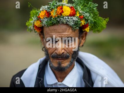 Portrait of a flower man with a floral crown on the head and kohl on his eyes, Asir province, Sarat Abidah, Saudi Arabia Stock Photo