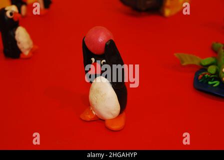 A close-up of a clay penguin, based on the animated TV character, Pingu, made during a children's educational play arts & crafts/model-making workshop Stock Photo