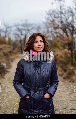 Portrait of young attractive woman in the mountains of the Pyrenees during winter season, Aragon, Spain Stock Photo