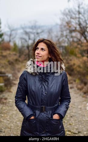 Portrait of young attractive woman in the mountains of the Pyrenees during winter season, Aragon, Spain Stock Photo