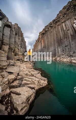 Tourist at Stuolagil Canyon, basalt columns, Egilsstadir, Iceland Stock Photo