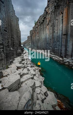 Tourist at Stuolagil Canyon, basalt columns, Egilsstadir, Iceland Stock Photo