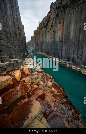 Tourist at Stuolagil Canyon, basalt columns, Egilsstadir, Iceland Stock Photo