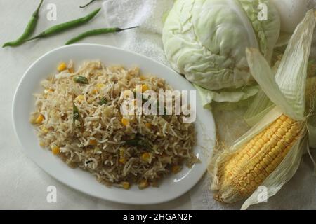 Cabbage corn fried rice. A tasty rice dish with sauteed cabbage and corn flavoured with garlic. A quick meal option with precooked basmati rice. Shot Stock Photo