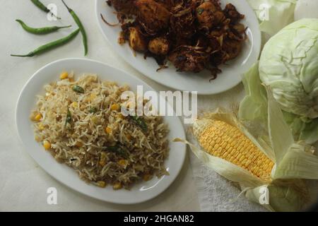 Cabbage corn fried rice. A tasty rice dish with sauteed cabbage and corn flavoured with garlic. A quick meal option served with chicken roast prepared Stock Photo