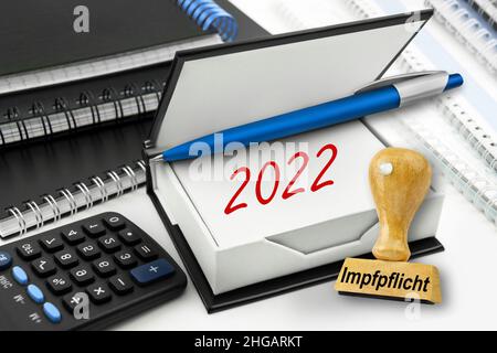 German Corona Compulsory Vaccination 2022 and calculator Stock Photo