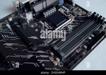 Engineer plugging CPU microprocessor to motherboard socket. Computer technology hardware maintenance or repair.  Electronics Development Working on Co Stock Photo