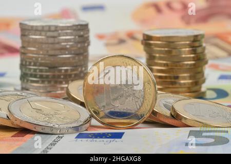 Stack of cent coins, euro coins, euro banknotes, studio shot Stock Photo