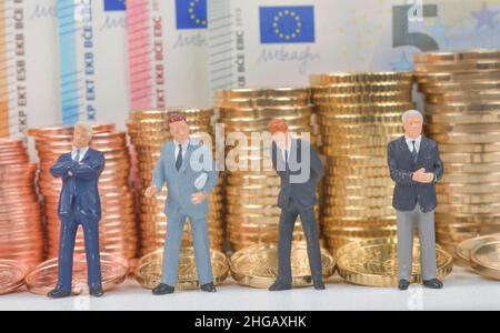Stacks of coins, cent coins, euro coins, miniature figures, symbol photo manager wage businessmen, studio photo Stock Photo