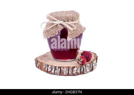 Strawberry jam and fresh berries on wooden stands isolated on white background.  Homemade jam concept, preparation for winter. Stock Photo