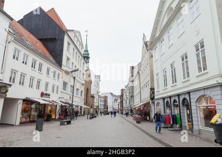 Flensburg, Germany - February 9, 2017: Grosse Strasse of Flensburg. It is a shopping street in center of the city. Ordinary people walk the street Stock Photo