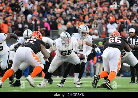 Las Vegas Raiders center Andre James walks with trainers after an