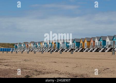 Coast and sandy beach at the North Sea in Vlissingen in the Netherlands. Colorful houses on the beach as bungalows. Stock Photo