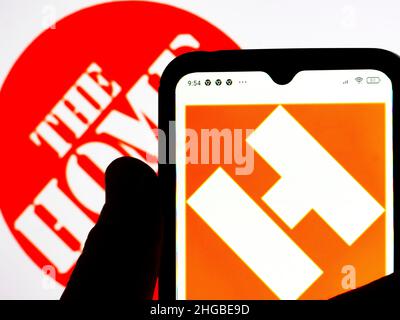 In this photo illustration, The Home Depot logo is seen displayed on a smartphone screen with the Home Depot logo in the background. Stock Photo