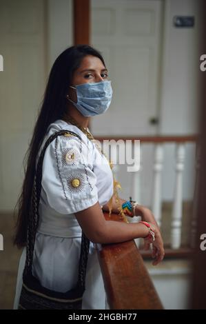 Portrait of young Arhuaco indigenous woman wearing a face mask during the Covid-19 outbreak in Colombia Stock Photo