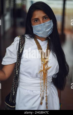 Portrait of young Arhuaco indigenous woman wearing a face mask during the Covid-19 outbreak in Colombia Stock Photo