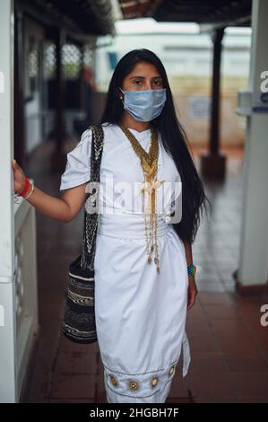 Portrait of young Arhuaco indigenous woman wearing a face mask during the Covid-19 outbreak in Colombia Stock Photo