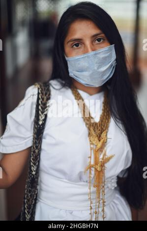 Portrait of young Arhuaco indigenous woman wearing a face mask during the Covid-19 outbreak in Colombia Stock Photo